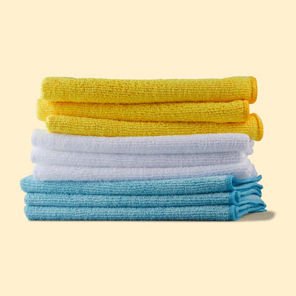 Folded yellow white and blue microfiber cleaning cloths stacked together