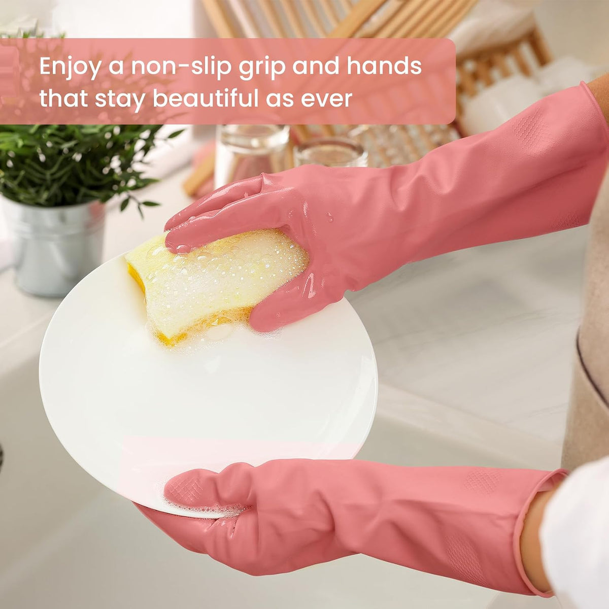 Reusable pink cleaning gloves washing a dish